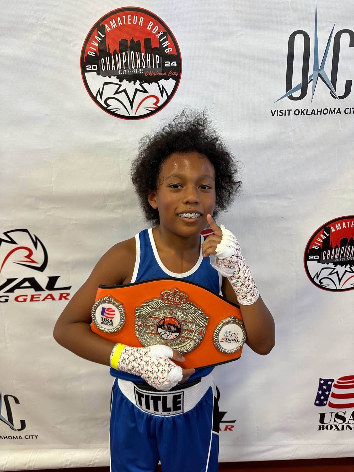 AM Pro Charities athlete proudly posing with a championship belt